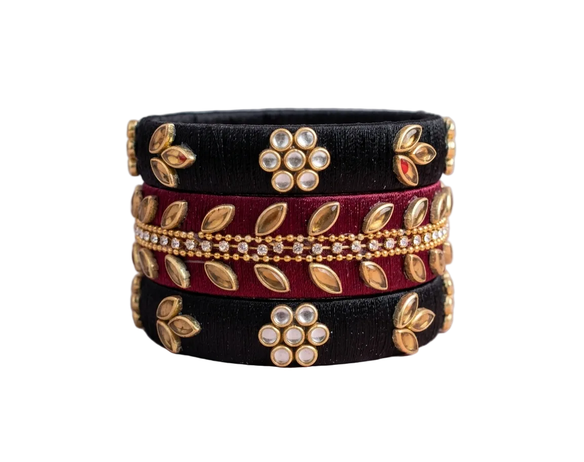 A set of handmade black and maroon silk thread bangles embellished with sparkling kundan stones and rhinestones from Dori Dot Collection.