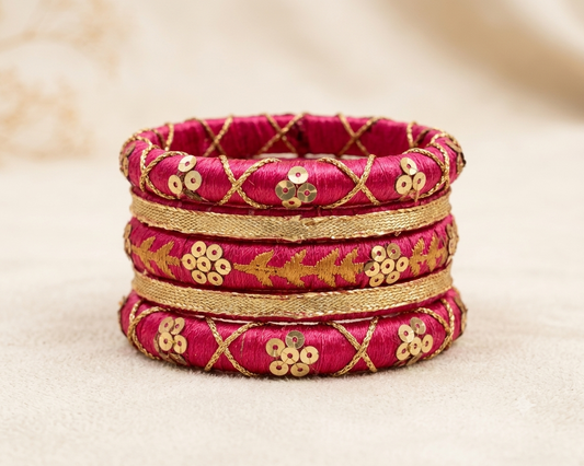 Gulnaar magenta silk thread bangles decorated with gold zari embroidery and sequin embellishments by Dori Dot Collection.