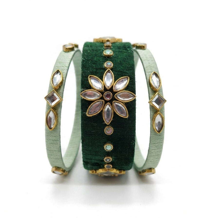 A set of three stacked bangles: a central dark green velvet band with a gold-tone floral kinkajou-style ornament, flanked by two light mint green velvet bands with gold-tone diamond-shaped and oval stone accents.